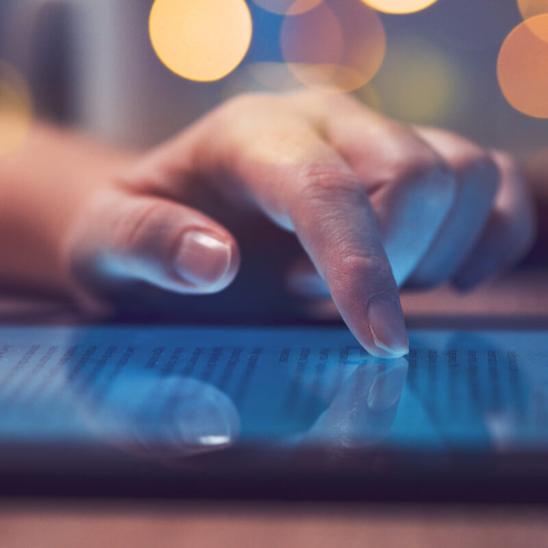 Woman reading online news on digital tablet